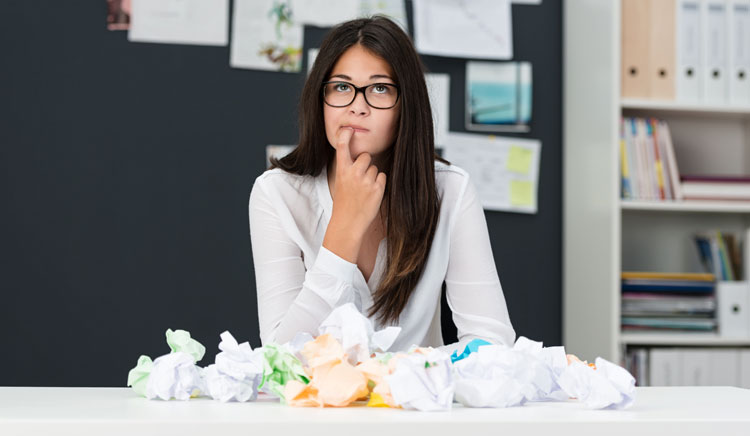 Photo of a woman with writers block, a common problem for business owners trying to find the words for their business website