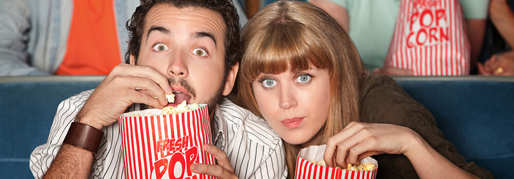 photo of a couple fully engaged in their movie, symbolic of how an effective website can keep users attention with great website pages filled with valuable website content and images
