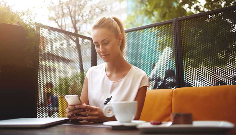 photo of a woman browsing a website from a coffee shop